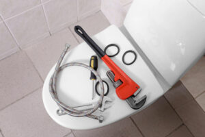 tools placed on toilet lid prepared for toilet repair